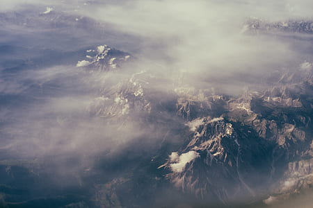 aerial view of mountain under cloudy sky thumbnail