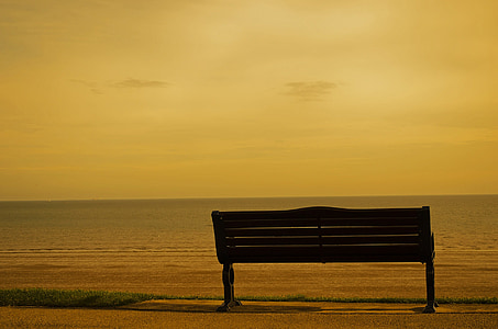 black metal bench near seashore thumbnail