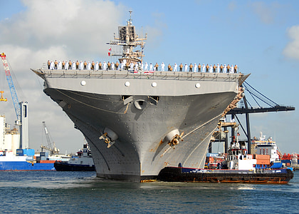 people on battle ship near dock thumbnail
