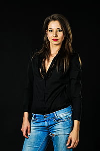 woman in black long-sleeved shirt and wash blue denim bottoms thumbnail