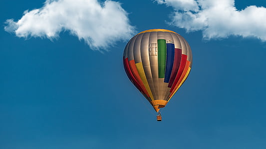 photography of multicolored hot air balloon under blue sky thumbnail