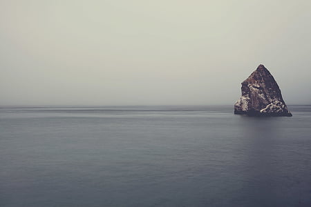 rock formation surrounded with body of water thumbnail