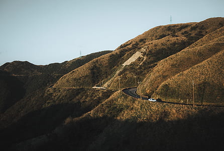 white car on road within mountain range thumbnail