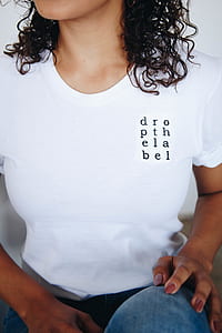 woman wearing white crew neck t-shirt sitting thumbnail