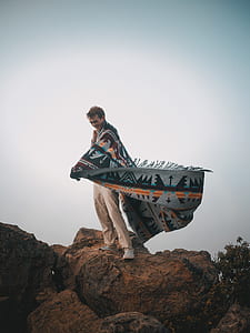 man standing on top of rock thumbnail