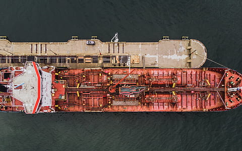 Aerial view of forward part of the hull of a ship docked at the port surrounded with sea water thumbnail