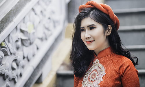 woman wearing orange floral top thumbnail