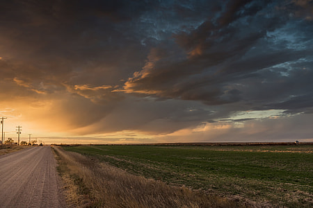 landscape photography of grass field beside the road thumbnail