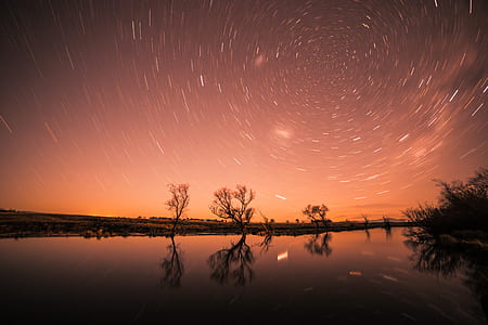 body of water photo under starry sky during nighttime thumbnail