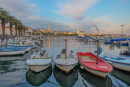 assorted-color boats on body of water near green palm trees at daytime thumbnail