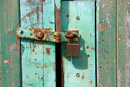 brown padlock on teal wooden door thumbnail