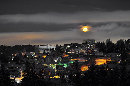 aerial photography of city building during night time with full moon thumbnail
