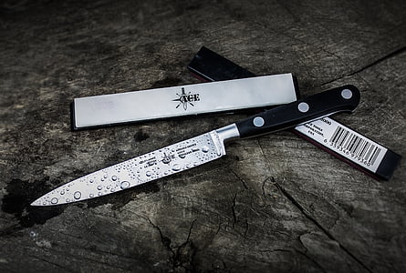 stainless steel knife on gray wooden table thumbnail