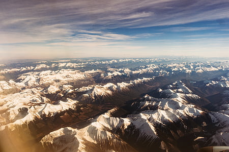 snow covered mountains under white clouds during daytime thumbnail