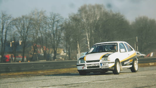 white 3-door hatchback on gray asphalted road thumbnail
