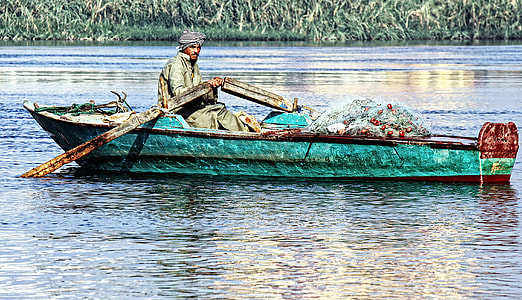man rowing canoe during daytime thumbnail