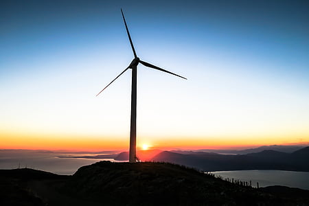 photo of wind mill near sea under clear blue sky during daytime thumbnail