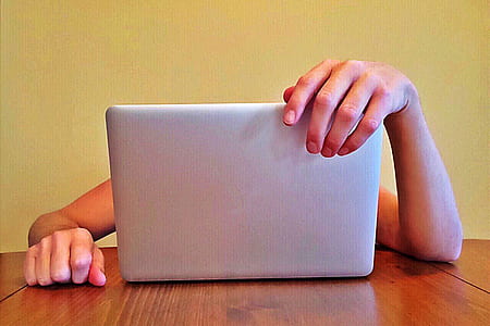person sitting neat gray laptop computer thumbnail