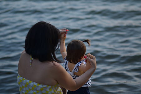 woman holding child hands thumbnail