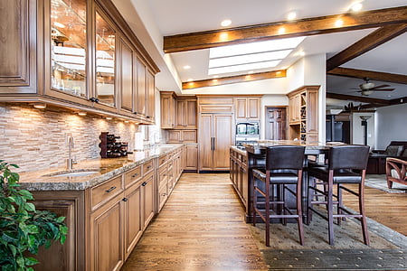 photo of brown wooden kitchen cupboards near kitchen island thumbnail
