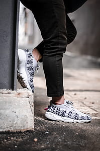 Person Wears Pair of Gray Low-top Sneakers thumbnail