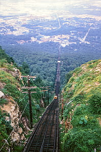 Electric Locomotive Track with train running between mountains in the background thumbnail