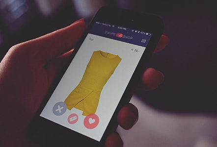 person holding black Android smartphone with yellow dress display thumbnail