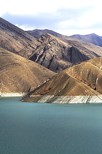 mountain terrain near body of water thumbnail