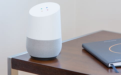 Google Home speaker on top of brown table thumbnail
