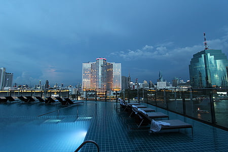 sun loungers near buildings thumbnail