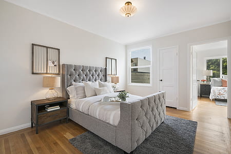 empty bed beside white door thumbnail