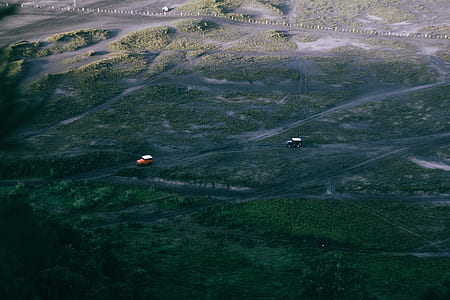 aerial view photography of two vehicles on road during daytime thumbnail