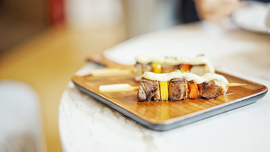 selective focus photography of kebab served on brown plate thumbnail