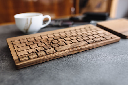 Young man typing on the wooden keyboard thumbnail