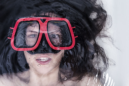 woman lying on water wearing snorkel goggles thumbnail
