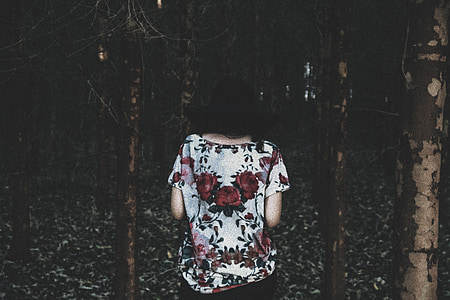 person wearing white and red floral boat-neck blouse in the middle of forest thumbnail
