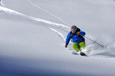 person ski boarding on snow-capped mountain during daytime thumbnail