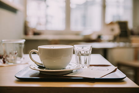 white ceramic teacup near shot glass on tray thumbnail