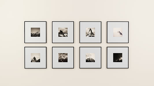 eight assorted framed mountain photos on white wall thumbnail