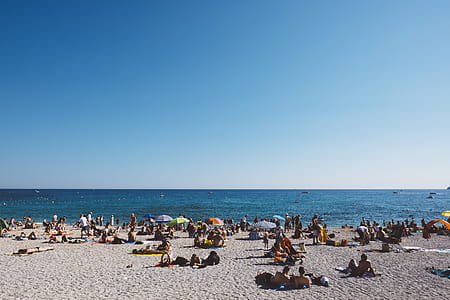 people sun bathing at the beach thumbnail