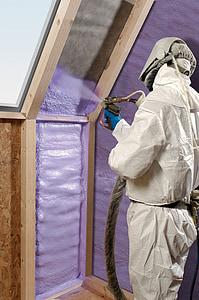 man spraying paint on gray wall thumbnail