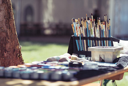 blue, black, and brown wooden paint brush in wooden table thumbnail