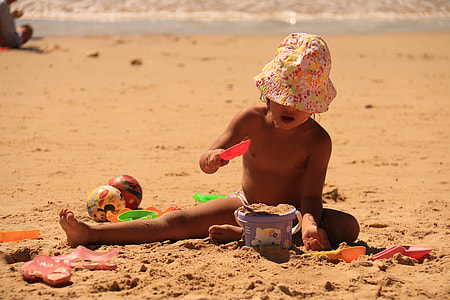 toddler playing on beach shore thumbnail