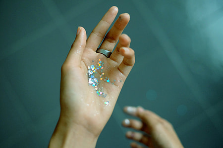 person showing assorted color glitters thumbnail
