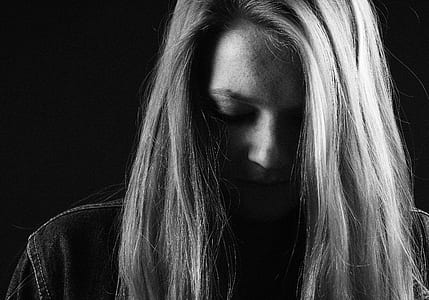grayscale photo of woman looking downwards thumbnail