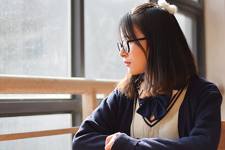 woman sitting beside glass window thumbnail