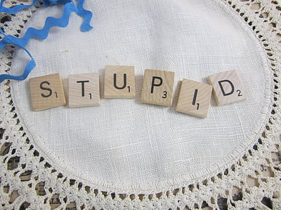 beige scrabble tiles on white tablecloth thumbnail