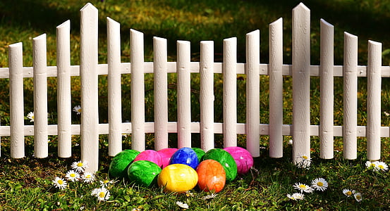 assorted-color stone near white wooden gate thumbnail