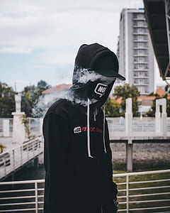 person wearing black cap and hoodie thumbnail
