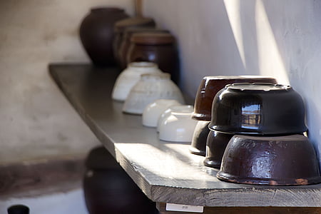 assorted-color ceramic bowls on rack thumbnail